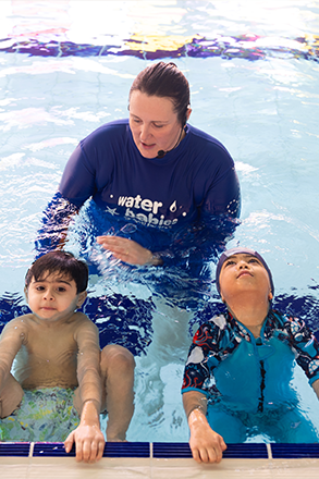 swimvincible teacher with two students in the pool