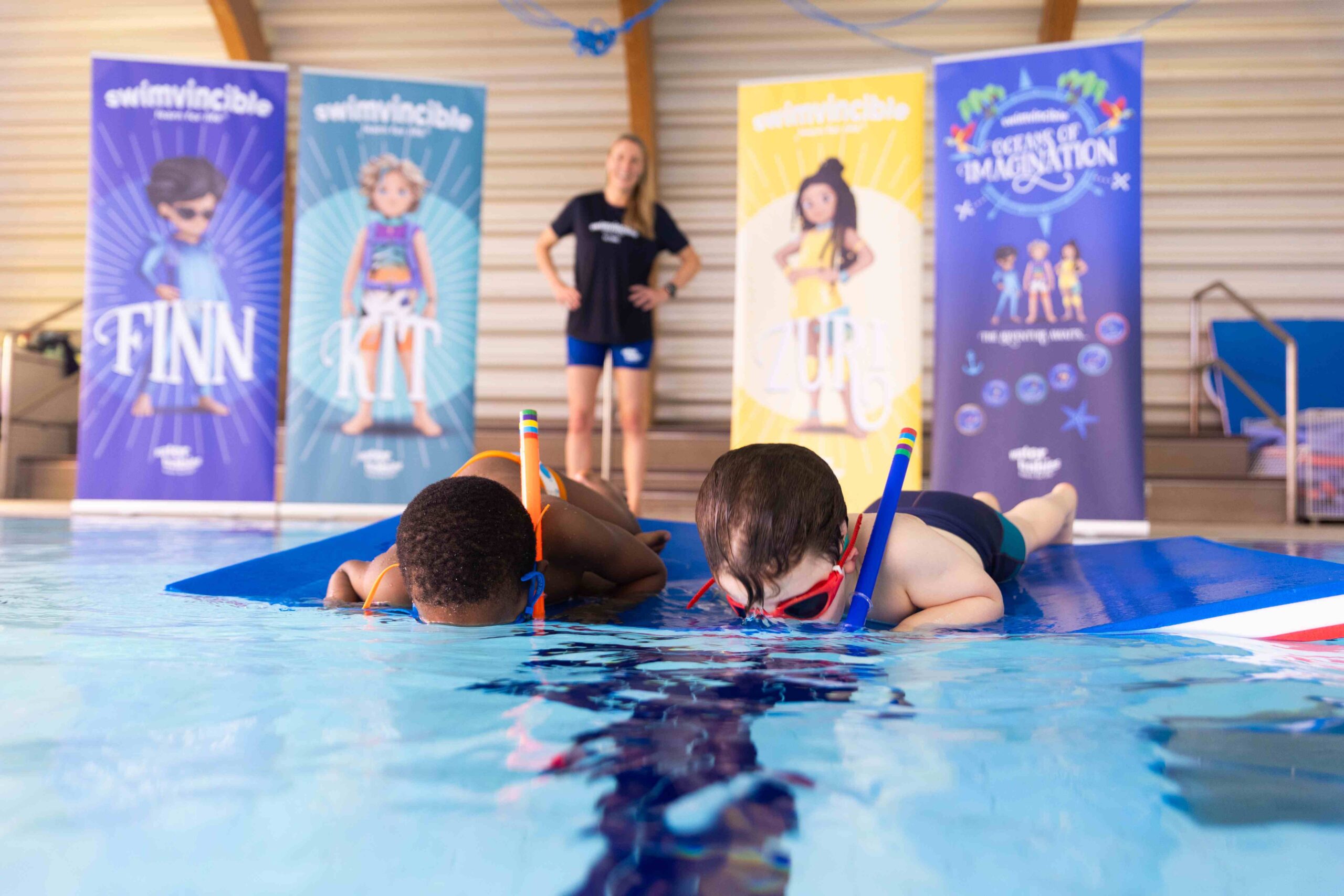 two children snorkelling in the pool