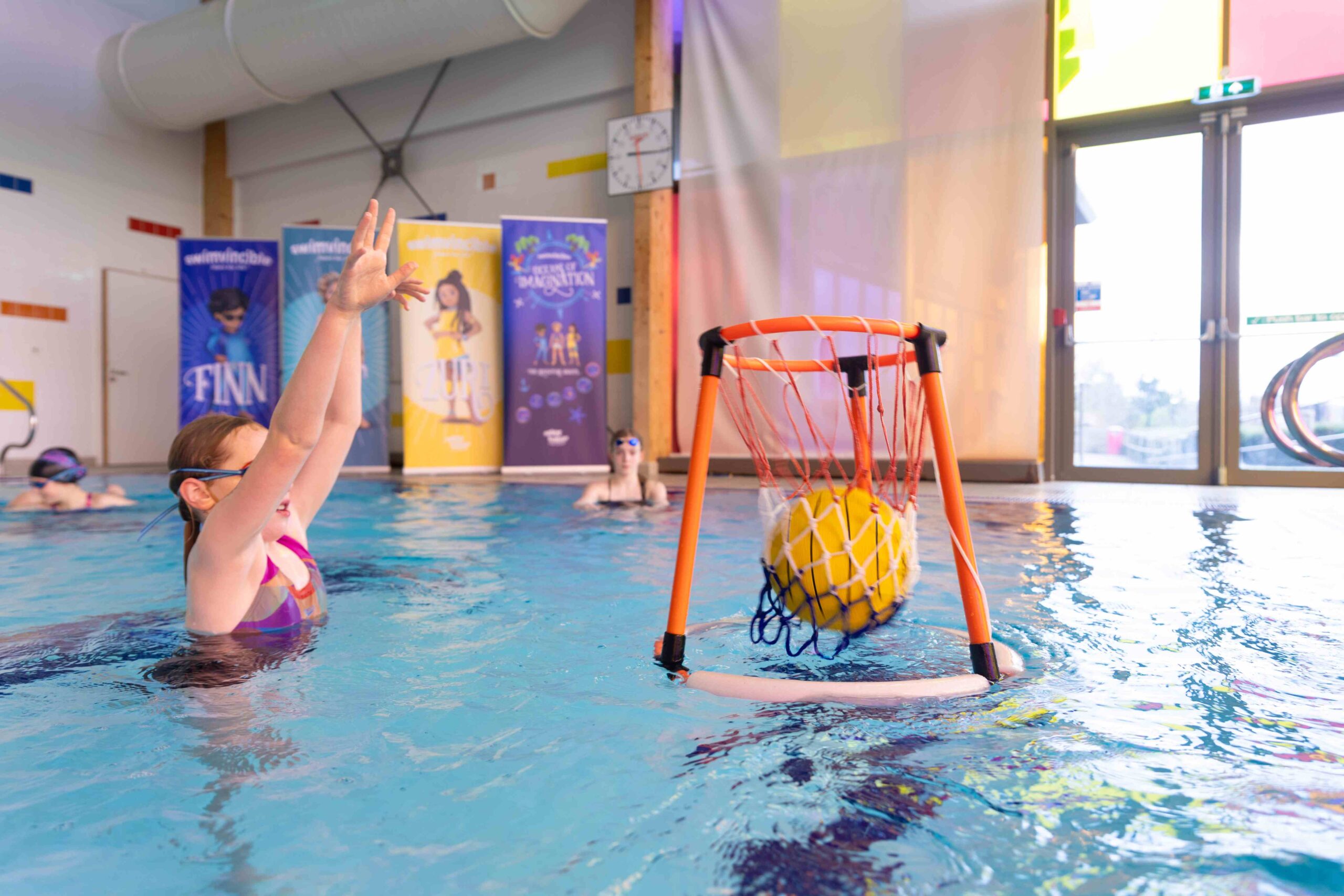 swimvincible student throwing a ball into the net