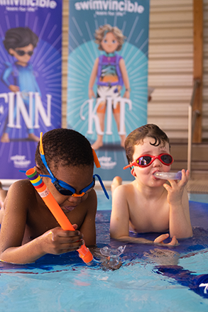 two swimmers on a mat in the water with snorkels on